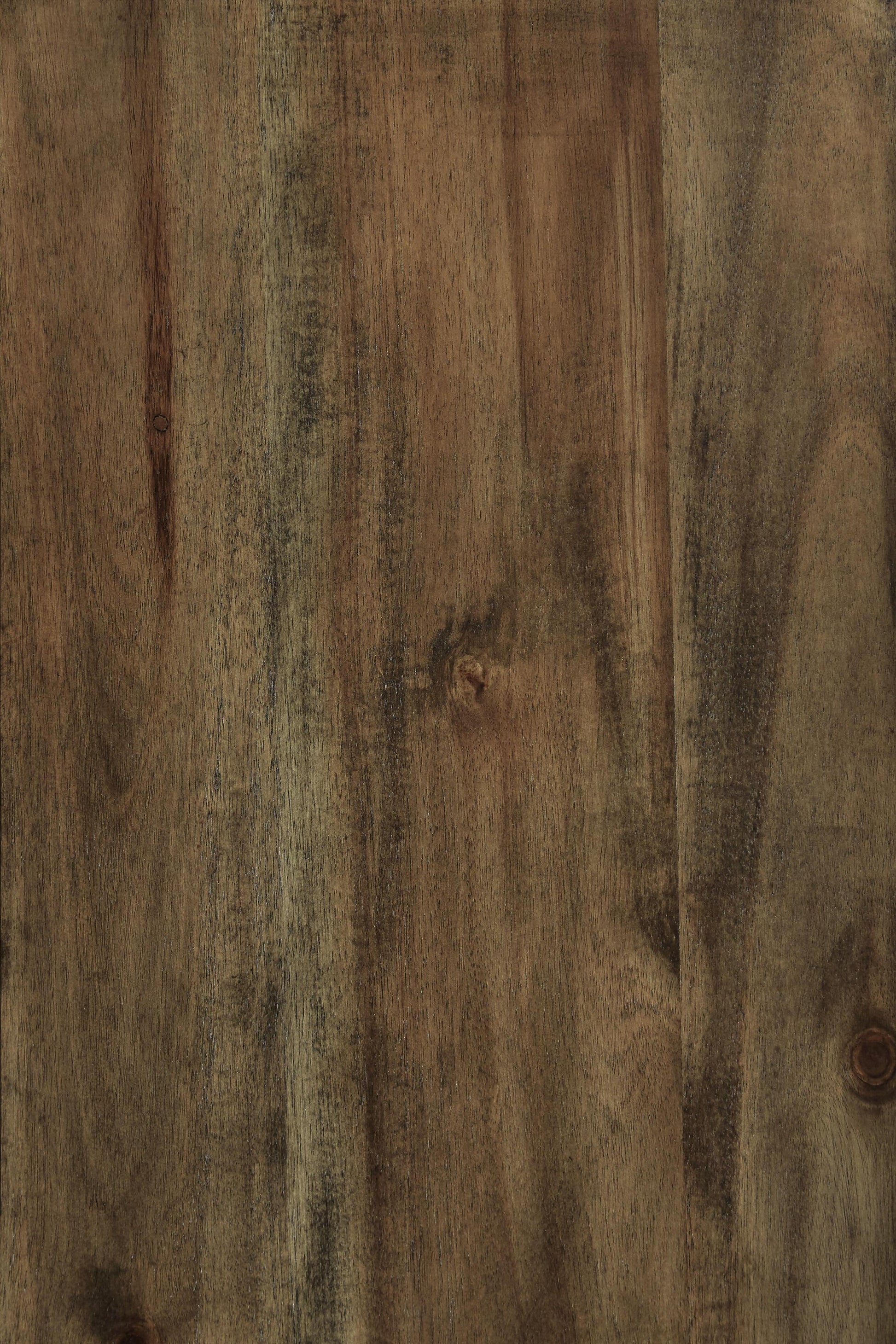 A close-up of the Moriville Dining Room Server’s wooden surface shows its distressed nutmeg finish, visible grain patterns, and subtle color variations—adding character to any dining space.