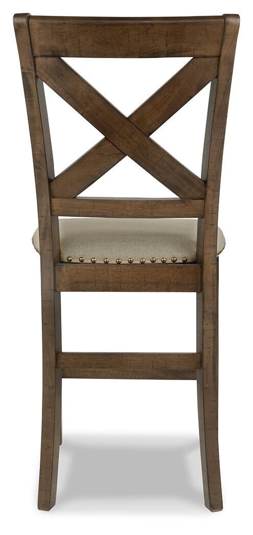 The Moriville Upholstered Barstool (2/CN) features an X-shaped backrest and decorative nailhead trim, shown from the back against a white background.