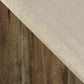 Diagonal split image features the Moriville Upholstered Barstool (2/CN): a textured beige fabric, similar to the barstool's seat, on the upper right and distressed nutmeg-finished dark brown wood on the lower left.