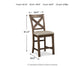 Moriville Upholstered Barstool (2/CN): Brown wooden barstool with beige cushion, X-back design, and distressed nutmeg finish. Measures 41.5"H x 19.5"W x 24.5"D; weight is 21 lbs.