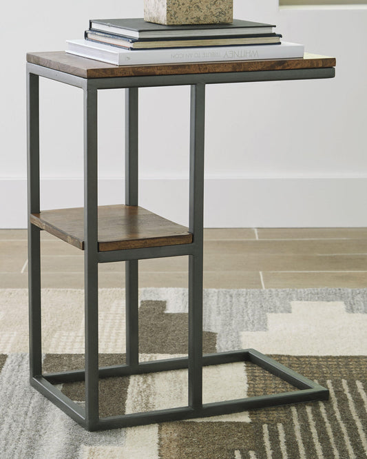 The Forestmin Accent Table features a black metal frame and rustic wood surfaces, topped with a stack of books, and sits elegantly on a patterned rug, adding minimalist-chic style to any space.