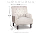 The Tartonelle Accent Chair features linen weave fabric, button tufted back, nailhead trim, and sturdy wooden legs. Dimensions: 37.25" H x 31.5" W x 35.5" D; weight: 50 lbs.