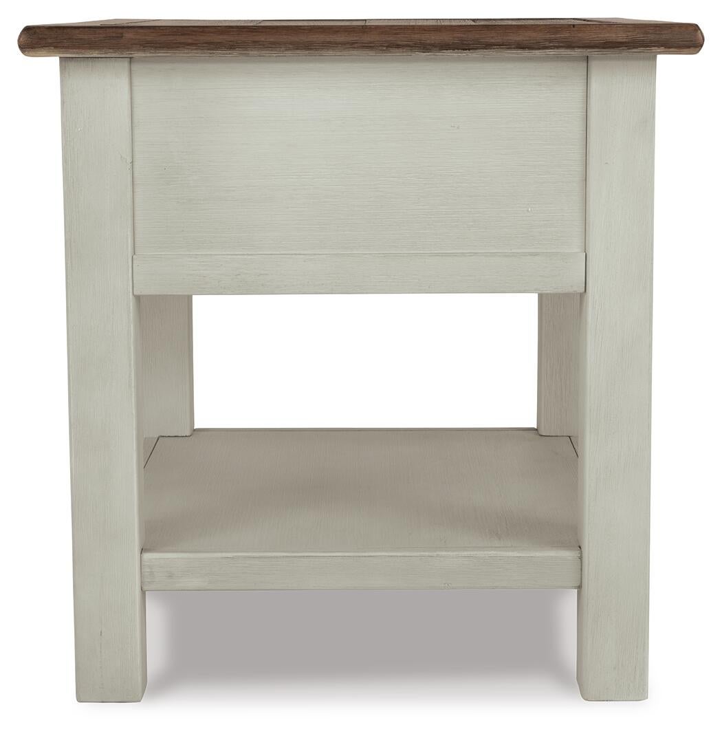 Front view of Bolanburg Rectangular End Table with a two-tone distressed finish, dark brown top, light-colored body, lower storage shelf, and a smooth-gliding drawer.