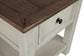 Close-up of the Bolanburg Rectangular End Table, featuring a dark brown top, white base, drawer with black knob, and a lower shelf—ideal for bringing shabby chic charm to your room.