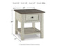 The Bolanburg Rectangular End Table features a two-tone distressed finish, dark top, smooth-gliding drawer, and lower shelf. Dimensions: 25" H x 24" W x 27" D. Weight: 49 lbs.