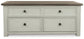 The Bolanburg Lift Top Cocktail Table features a dark wood top, four drawers with black round knobs, and an antique white body finish—offering both storage and charm to any room.