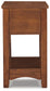The Breegin Chair Side End Table features a smooth top, solid sides, and lower shelf, finished in a warm medium brown.