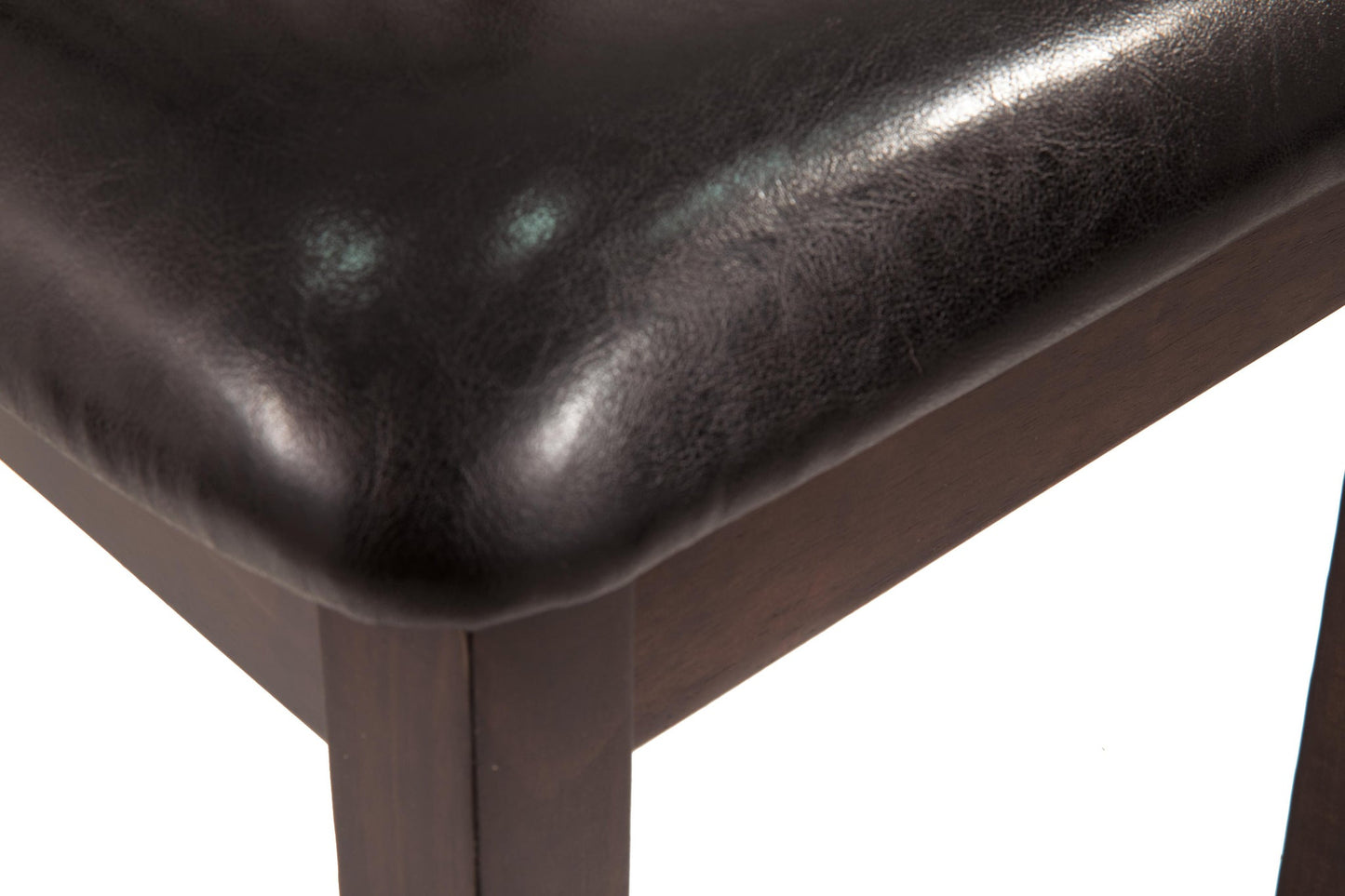 Close-up of the corner of the Hammis Dining UPH Side Chair in dark brown, featuring a black leather or faux leather padded seat.