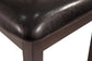 Close-up of the corner of the Hammis Dining UPH Side Chair in dark brown, featuring a black leather or faux leather padded seat.