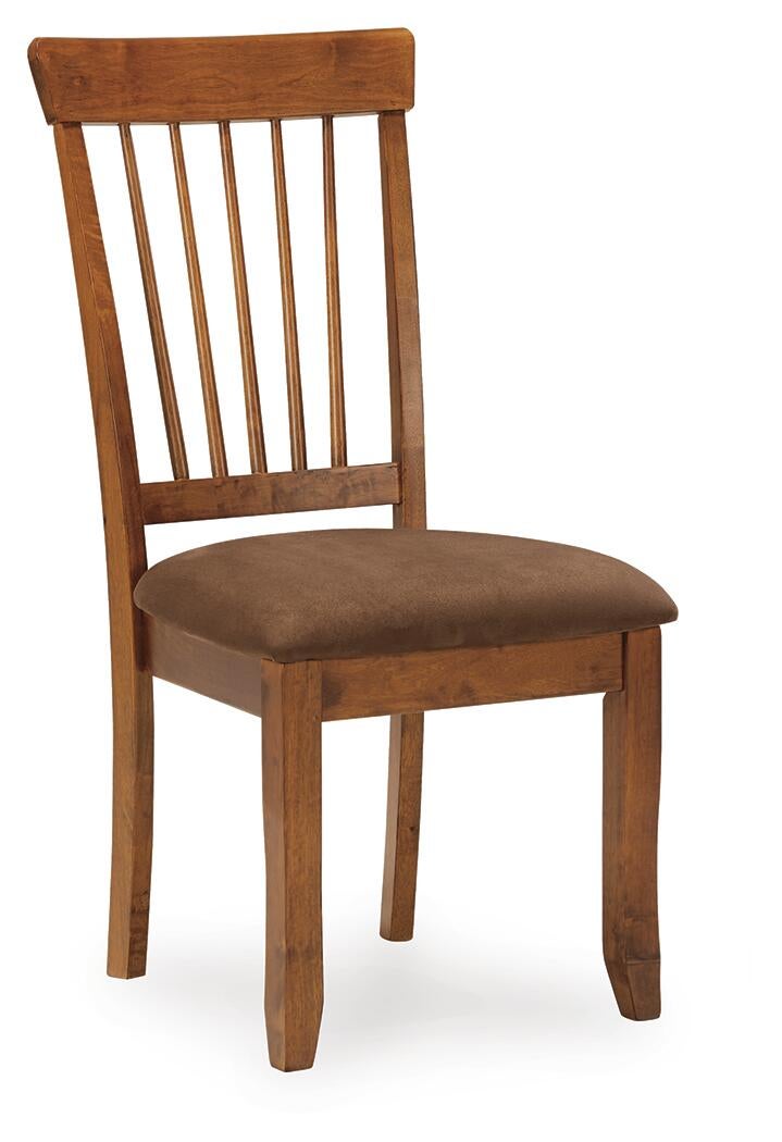 The Berringer Dining UPH Side Chair (2/CN) features a wooden spindle back and a cushioned brown microfiber seat, displayed against a white background.