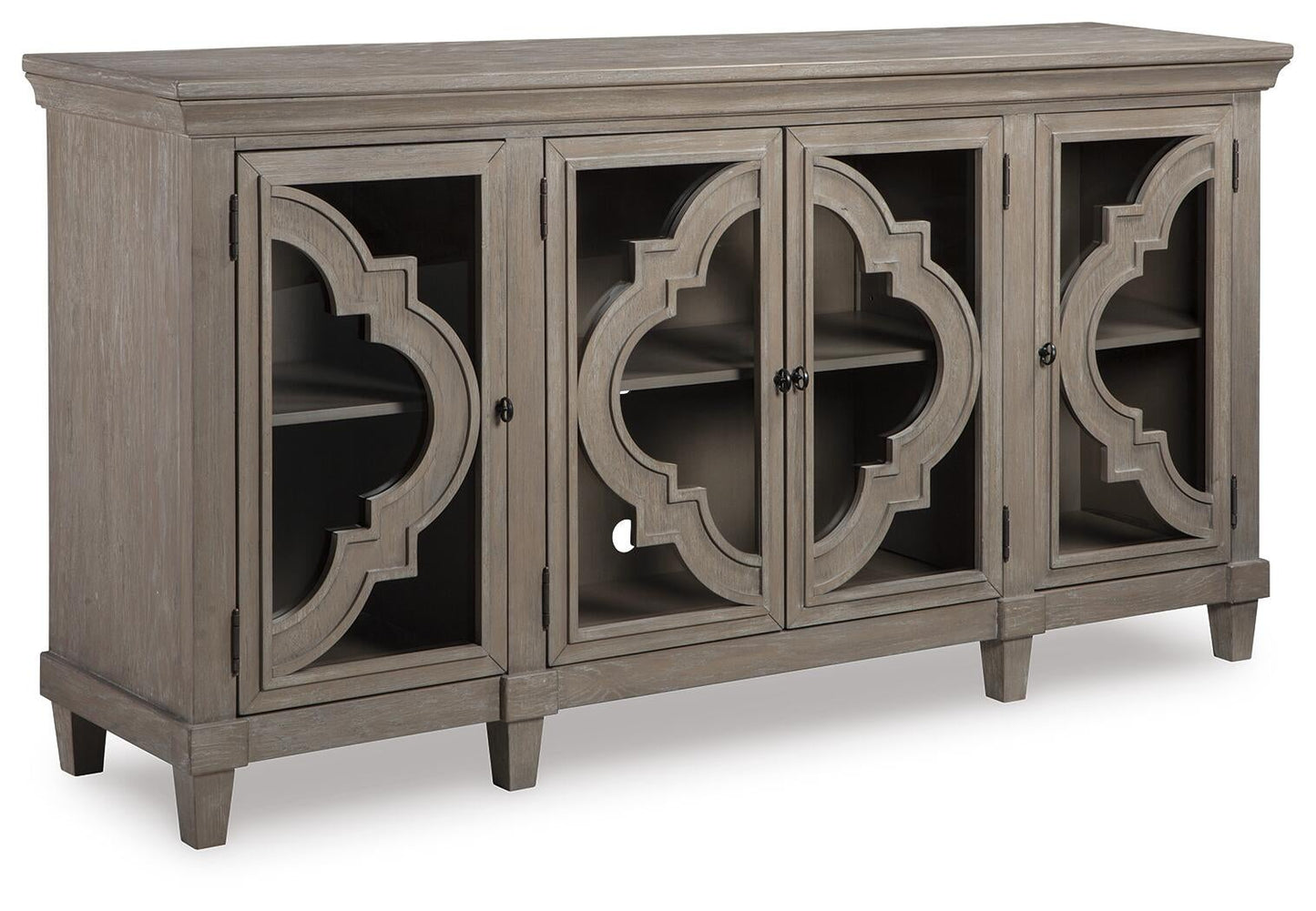 The Fossil Ridge Accent Cabinet is a gray wooden 4-door cabinet with glass inlays, decorative geometric patterns, two adjustable shelves inside, and short legs.