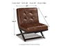 The Sidewinder Accent Chair features brown faux leather with a tufted seat and backrest, inspired by the classic Barcelona chair; measures 34.5"H x 28"W x 35"D, seat width 28", and weighs 31 lbs.