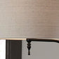 Close-up of the Anemoon Metal Floor Lamp (1/CN), featuring a beige fabric lampshade with a decorative dark metal finial and an elegant metal base, set against a neutral background.