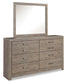 The Culverbach Dresser and Mirror features a weathered driftwood finish, eight drawers with rectangular handles, and a large matching rectangular mirror in a wooden frame.