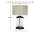 Tailynn Glass Table Lamp (1/CN) with a beige drum shade and clear textured glass base; 25.25"H x 16"W x 16"D, weighs 6 lbs.