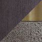 Diagonal split image showcasing the sleek, dark brown base of the Jacek Metal Table Lamp (2/CN) on the left and its metallic faux concrete surface with a bold brass-tone band on the right.