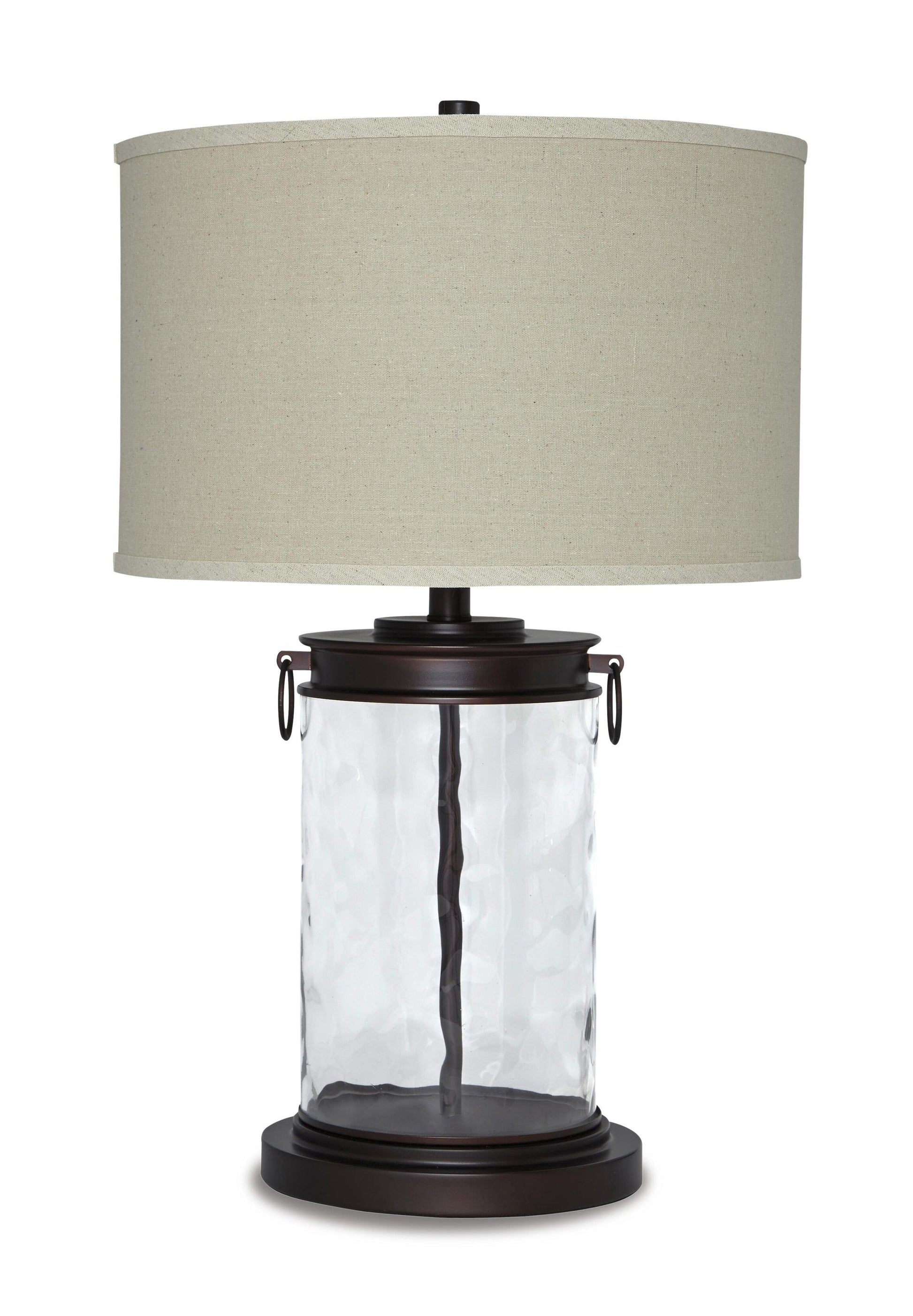 The Tailynn Glass Table Lamp (1/CN) features a clear textured cylindrical glass base, dark metal accents, and a large beige drum shade, providing stylish illumination.