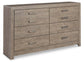 The Culverbach Six Drawer Dresser features a weathered driftwood finish and six spacious drawers in two rows, each fitted with a rectangular metal handle.