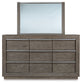 Anibecca Queen Upholstered Panel Bed with Mirrored Dresser and Chest at Walker Mattress and Furniture