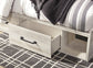 Cambeck King Panel Bed with 2 Storage Drawers with Mirrored Dresser, Chest and Nightstand at Walker Mattress and Furniture Locations in Cedar Park and Belton TX.