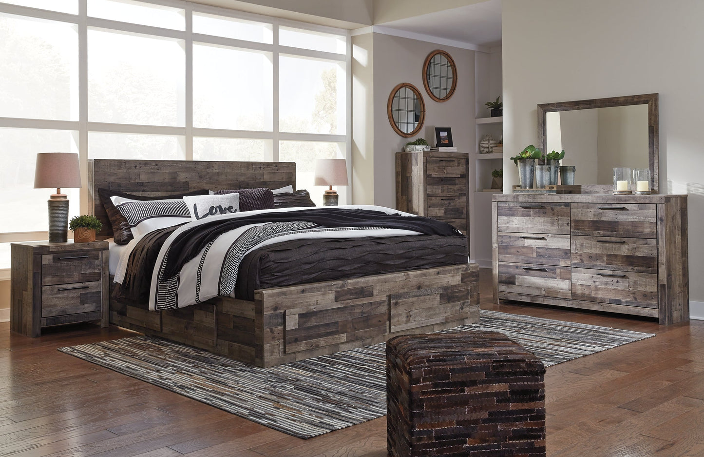 Derekson King Panel Bed with 4 Storage Drawers with Mirrored Dresser, Chest and Nightstand at Walker Mattress and Furniture Locations in Cedar Park and Belton TX.