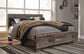 Derekson King Panel Bed with Mirrored Dresser, Chest and Nightstand at Walker Mattress and Furniture Locations in Cedar Park and Belton TX.