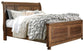 Flynnter King Panel Bed with 2 Storage Drawers with Mirrored Dresser, Chest and Nightstand at Walker Mattress and Furniture Locations in Cedar Park and Belton TX.