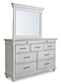 Kanwyn King Panel Bed with Storage with Mirrored Dresser, Chest and Nightstand at Walker Mattress and Furniture Locations in Cedar Park and Belton TX.